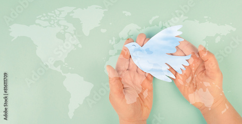 Dove flying from hand, international peace day, faith, freedom, charity and help concept, humanitarian aid, world map