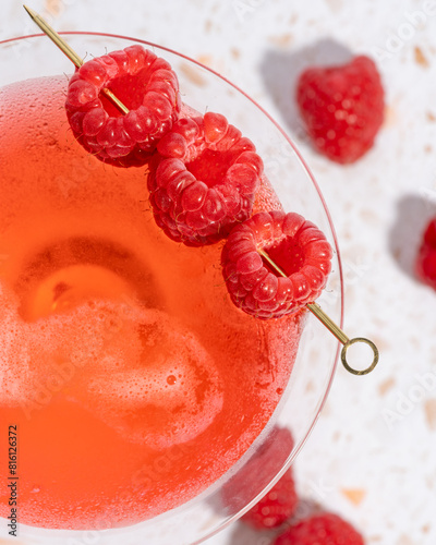 Raspberry garnished pink cocktail drink