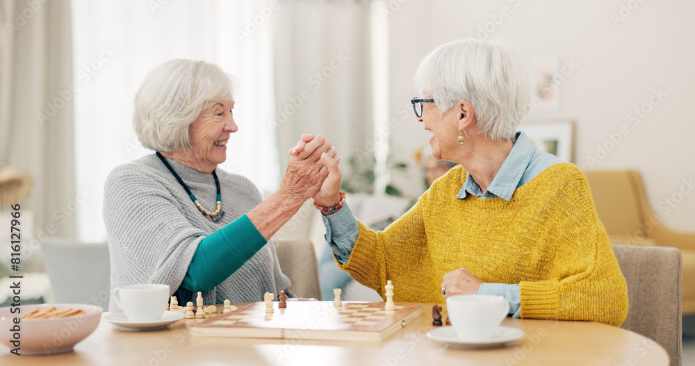 Senior woman, friends and high five for chess match, game or winning on table together at home. Happy elderly women in celebration, playing strategic board game for victory or checkmate in retirement Senior woman, friends and high five for chess match, game or winning on table together at home. Happy elderly women in celebration, playing strategic board game for victory or checkmate in retirement