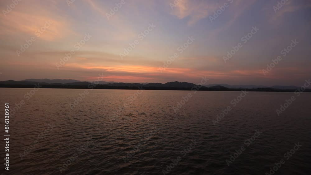 High angle video background with mountain scenery The river and the beautiful sunshine blurred onto the water surface in a golden light, the beauty of nature during the trip.