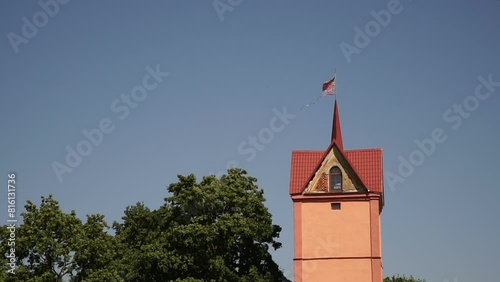 Flag on the estate tower. Medieval flag on the castle tower. Palace with a tower.