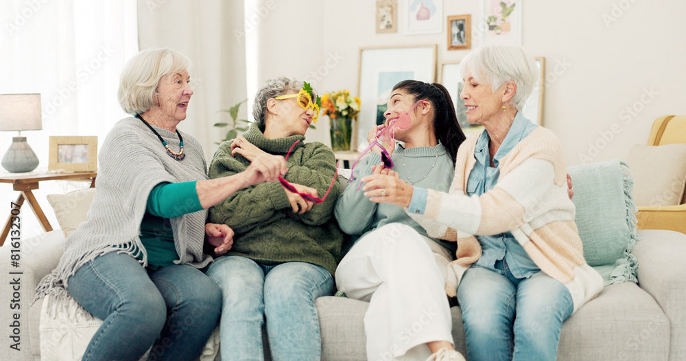 Happy, glasses and senior women face on the living room sofa for fun, playing and comedy. Smile, laughing and portrait of elderly friends or people with sunglasses, bonding and comic on the couch Happy, glasses and senior women face on the living room sofa for fun, playing and comedy. Smile, laughing and portrait of elderly friends or people with sunglasses, bonding and comic on the couch
