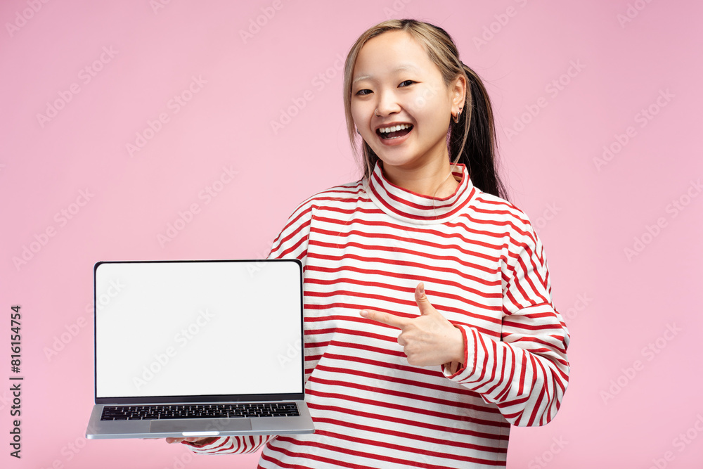 Smiling Asian student girl showing thumbs up holding laptop, screen for copy space Smiling Asian student girl showing thumbs up holding laptop, screen for copy space