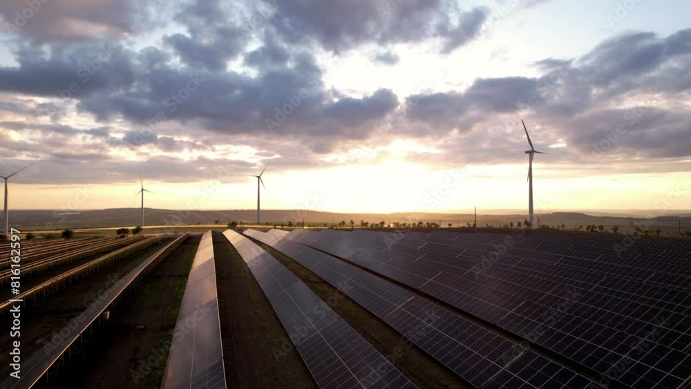 Solar panel generating green energy.Green energy reduce carbon emissions and makes earth cleaner and more ecological.Photovoltaic power station and wind turbines at sunset. Solar panel generating green energy.Green energy reduce carbon emissions and makes earth cleaner and more ecological.Photovoltaic power station and wind turbines at sunset.
