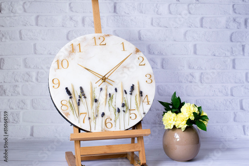 Clock. Clock hands. Clock on the table on the easel