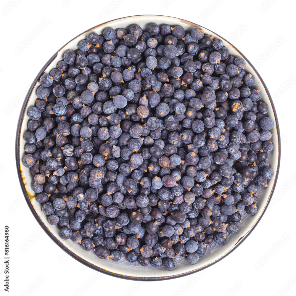 Dried juniper berries on plate above isolated Dried juniper berries on plate above isolated
