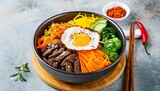 traditional korean dish bibimbap with fried agg beef and vegetables