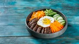traditional korean dish bibimbap with fried agg beef and vegetables