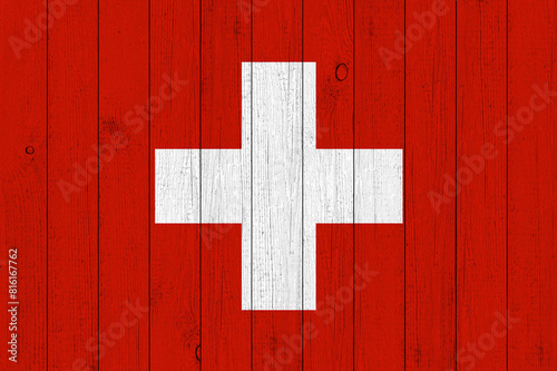 Flag of Switzerland on old grunge wooden panels surface background