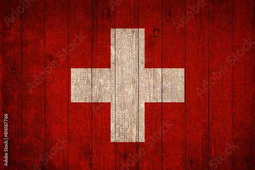 Flag of Switzerland on old grunge wooden surface background