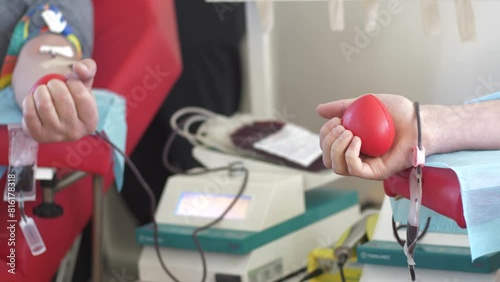 Blood donor at donation with a bouncy ball holding in hand.