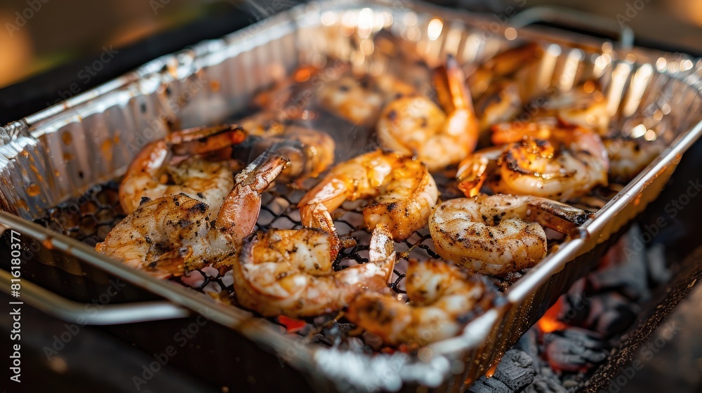 Grilled shrimp cooked on a metal grill over charcoal in a container Grilled shrimp cooked on a metal grill over charcoal in a container