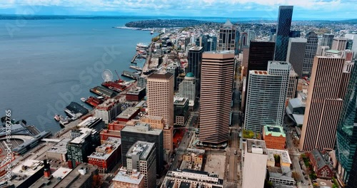 Lively downtown of amazing Seattle, Washington State, the USA at daytime. Waterfront of the modern city with diverse architecture, piers and Ferris wheel. Top view. photo
