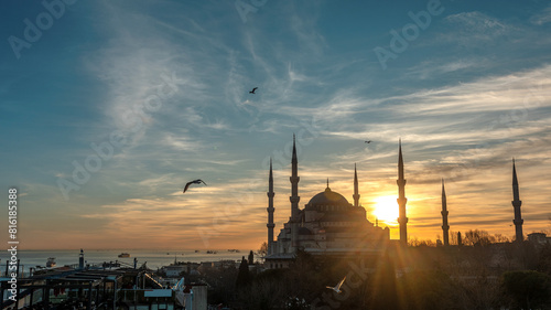 The Blue Mosque (Sultanahmet Camii) with seagulls against the sunset. Istanbul, Turkey.