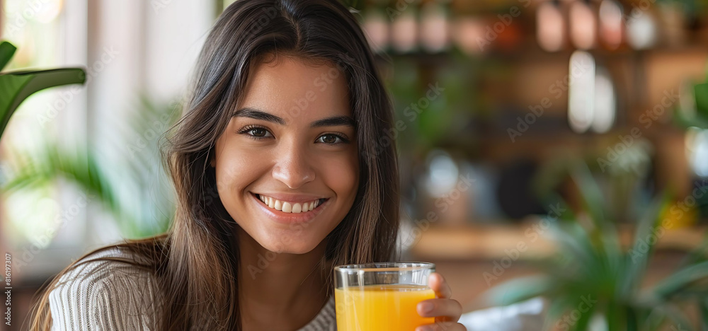 Smiling Latin woman with orange juice Smiling Latin woman with orange juice