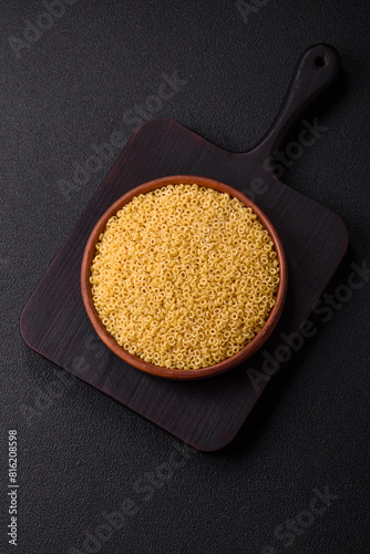 Raw anellini pasta from durum wheat with salt and spices photo