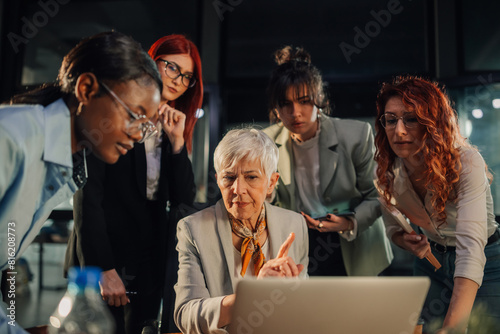 Executive criticize her junior unprofessional team and looking at laptop