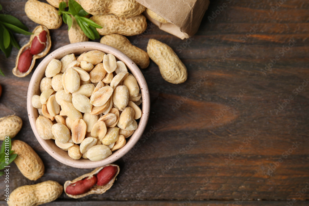 Fresh peanuts and leaves on wooden table, flat lay. Space for text Fresh peanuts and leaves on wooden table, flat lay. Space for text