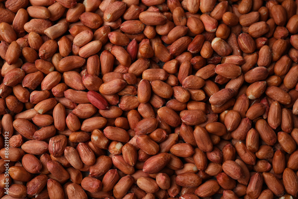 Many fresh unpeeled peanuts as background, top view Many fresh unpeeled peanuts as background, top view
