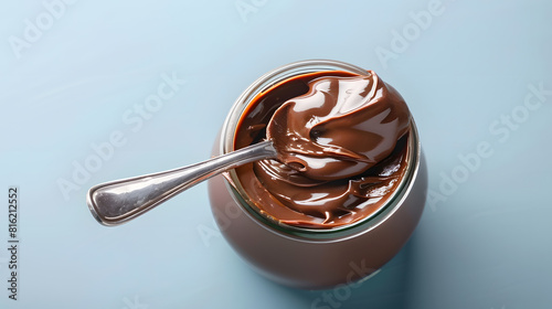 Empty jar of chocolate nut spread with a spoon on a light blue background Favorite delicacy traditionally for breakfast popular sweet paste for sandwiches and baked goods : Generative AI