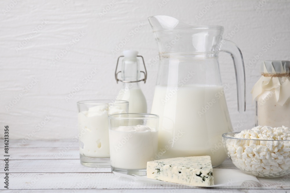 Different fresh dairy products on white wooden table. Space for text Different fresh dairy products on white wooden table. Space for text