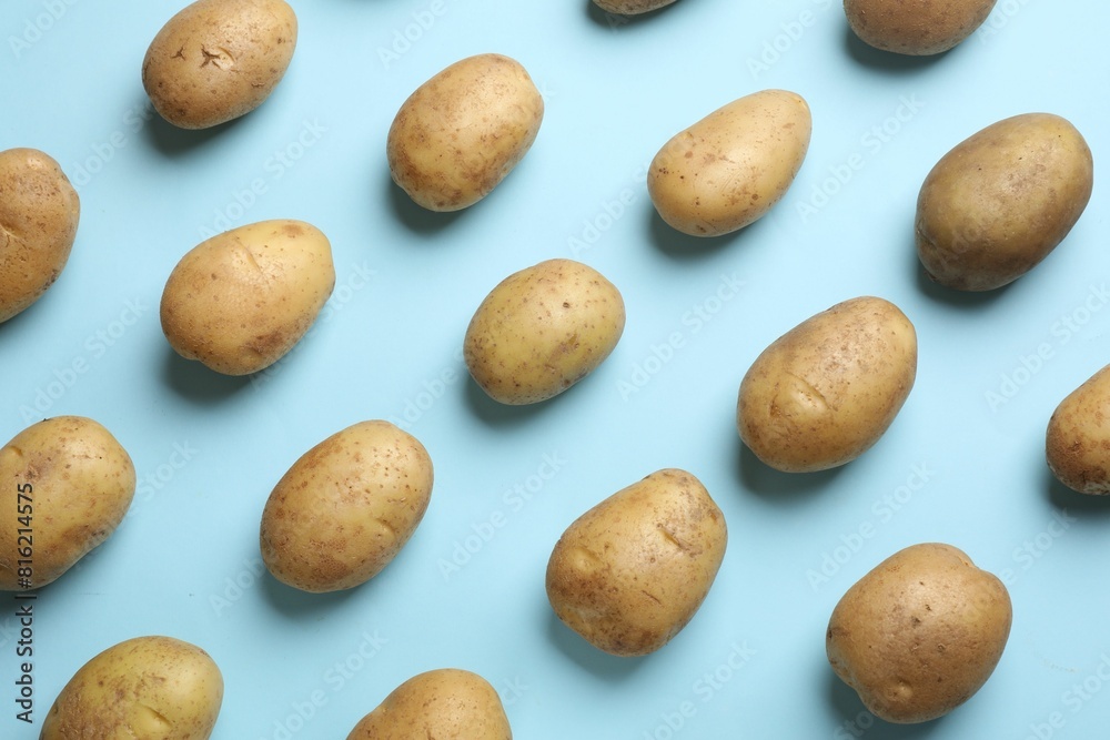 Many fresh potatoes on light blue background, flat lay Many fresh potatoes on light blue background, flat lay