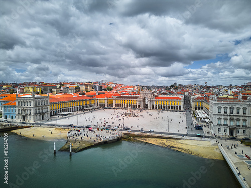 Aerial view of Lisbon, Portugal. View of the famous Augusta Arch, Commercial Square, and Tagus river on a sunny day with fluffy clouds