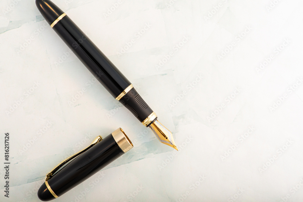 Fountain pens on light marbled surface, selective focus Fountain pens on light marbled surface, selective focus