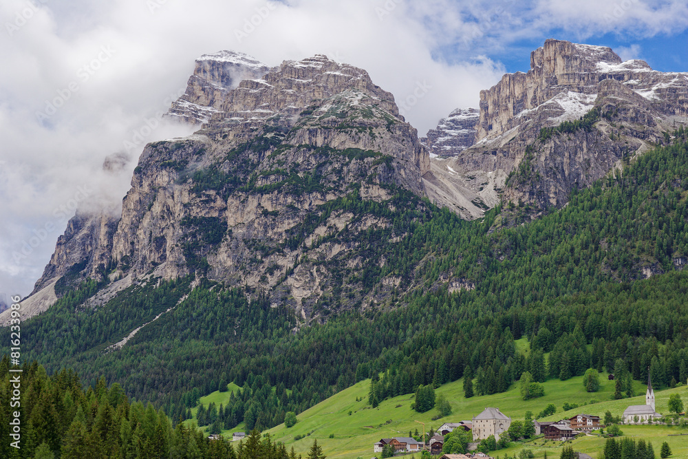 Naklejka premium Small rural village nestled in the Dolomite Mountains Italy.Green morning scene of countryside in Swiss Alps, Bernese italian in the canton of Bern, Switzerland, Europe. Alpine mountain pasture