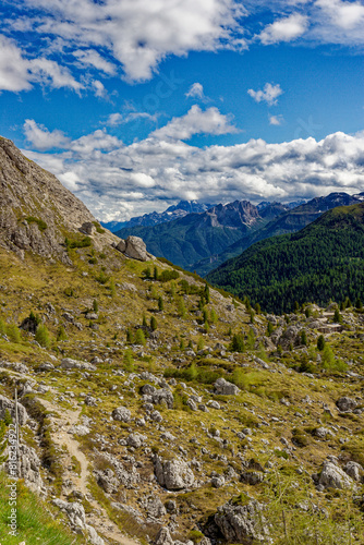 Alpine scenes of the Dolomite mountains Italy. With lush green pastures and snow topped mountain vistas. Mountain lake Laghi dei Piani near Tre Cime in Dolomites. Panorama of beautiful mountains.
