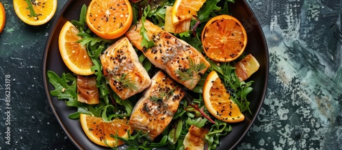 Grilled salmon and orange slices on plate