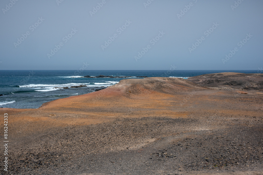 Arid, volcanic landscape of the southern side of Jandia Nature Reserve, Jandia Peninsula, Fuerteventura, Spain Arid, volcanic landscape of the southern side of Jandia Nature Reserve, Jandia Peninsula, Fuerteventura, Spain