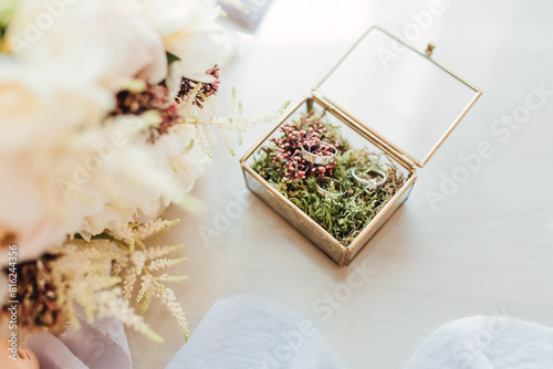 Wedding rings in a beautiful handmade glass box with flowers