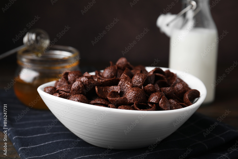 Breakfast cereal. Chocolate corn flakes in bowl on table, closeup Breakfast cereal. Chocolate corn flakes in bowl on table, closeup
