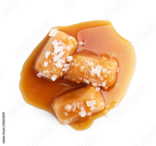 Yummy caramel candies and sea salt isolated on white, top view