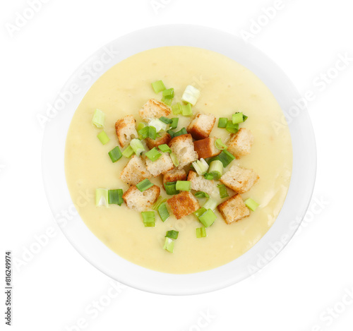 Tasty potato soup with croutons and green onion in bowl isolated on white, top view