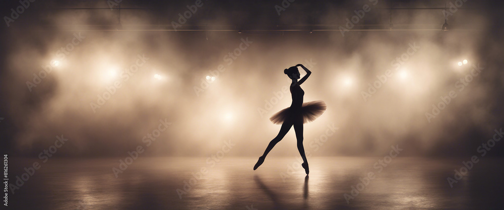 silhouette of a beautiful and talented ballerina woman in front of spotlights and smoke
