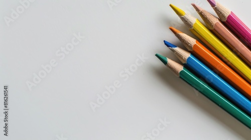 Colored pencils set on a plain white background with space for text