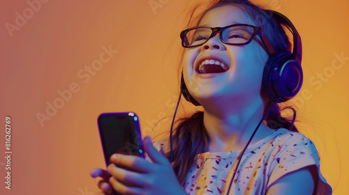 4yearold brunette Latin girl with glasses listens to music in her headphones connected to her cell phone dances sings and enjoys the rhythm happy and excited : Generative AI photo