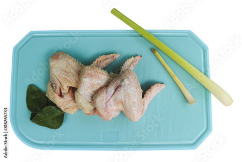 Uncooked or raw chicken wings on cutting board with ingredients.