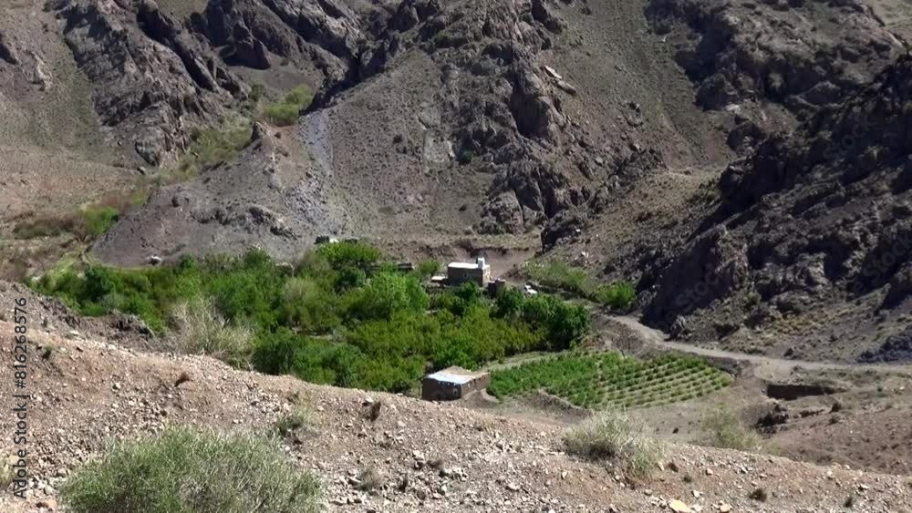 Extreme long shot of a breathtaking view of a green village nestled in ...