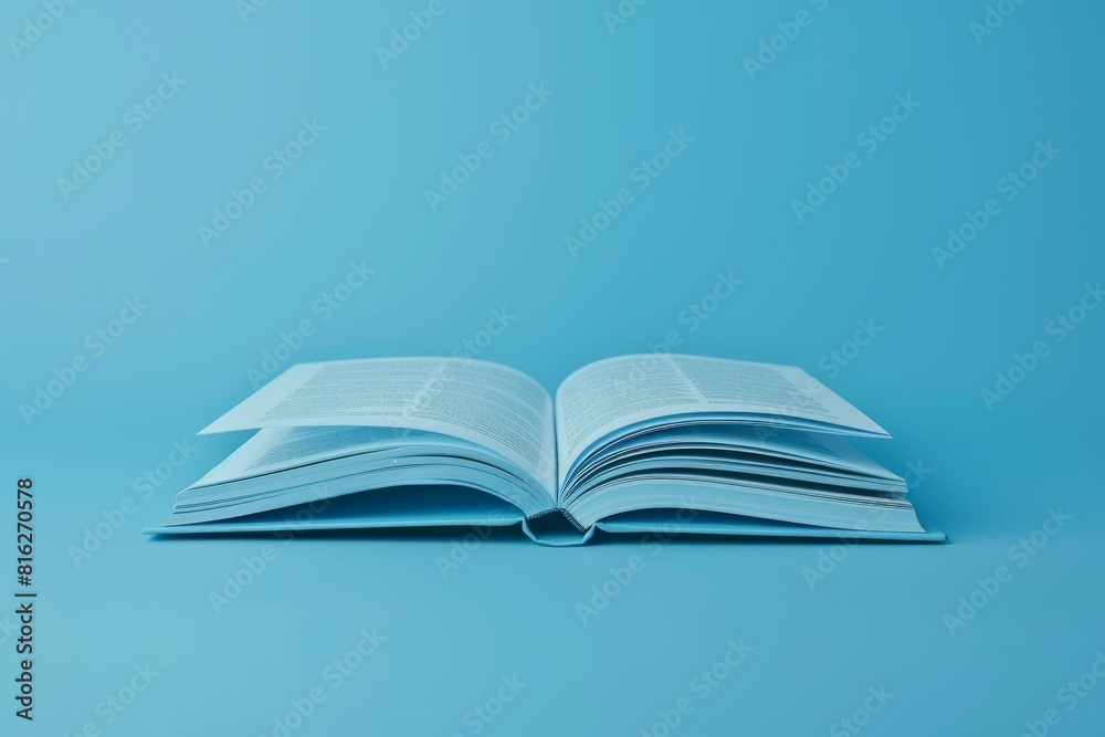 Open book on vibrant blue background, showcasing study and learning concepts with focus on knowledge and education in modern academic or office settings. Open book on vibrant blue background, showcasing study and learning concepts with focus on knowledge and education in modern academic or office settings.