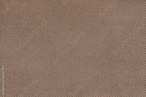 Plain brown velor upholstery fabric, jacquard with fine diamond texture background. Close up, macro cloth textile surface. Wallpaper, backdrop with copy space