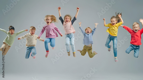 childhood motion and happiness concept  happy little children jumping in air over grey background : Generative AI