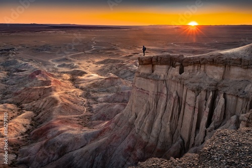 Tourist standing on rock formation Tsagaan Suvarga, White Stupa, View at sunrise, Dornogovi Aimag,, Mongolia, Asia photo