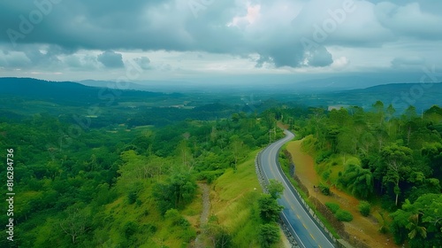 Aerial view of asphalt road and green forest  Beautiful fresh green natural scenery of hilltop. Healthy environment. Natural landscape.