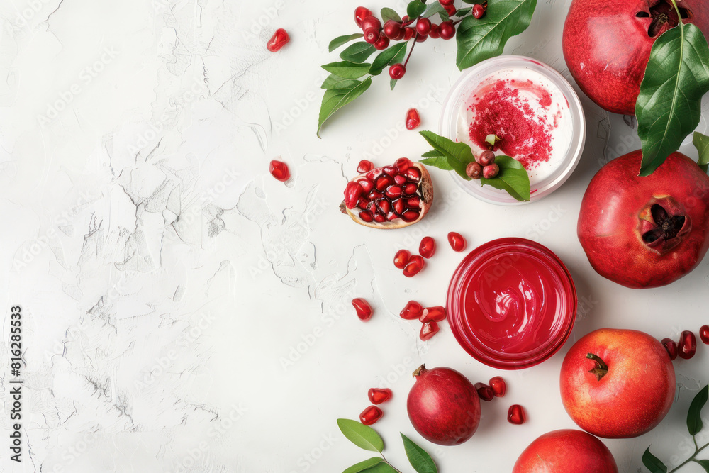 natural pomegranate skincare products arranged with fresh fruit on a white background natural pomegranate skincare products arranged with fresh fruit on a white background
