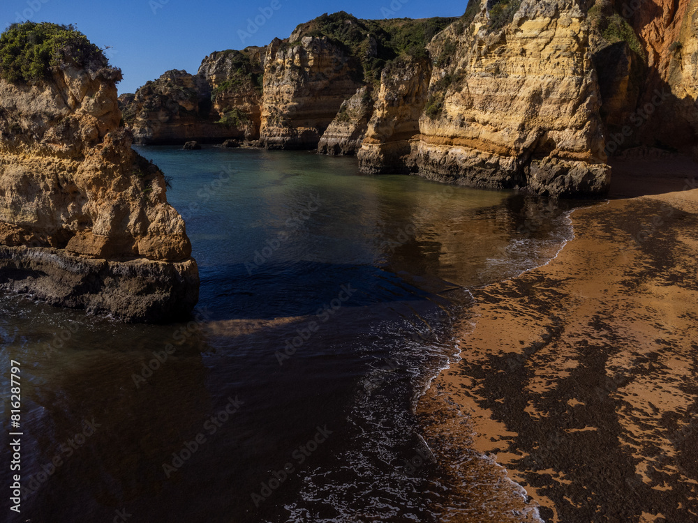 Praia de Dona Ana beach near Lagos town, Algarve, Portugal. Praia Dona Ana beach with turquoise sea water and cliffs, Portugal. Drone aerial view Praia de Dona Ana beach near Lagos town, Algarve, Portugal. Praia Dona Ana beach with turquoise sea water and cliffs, Portugal. Drone aerial view
