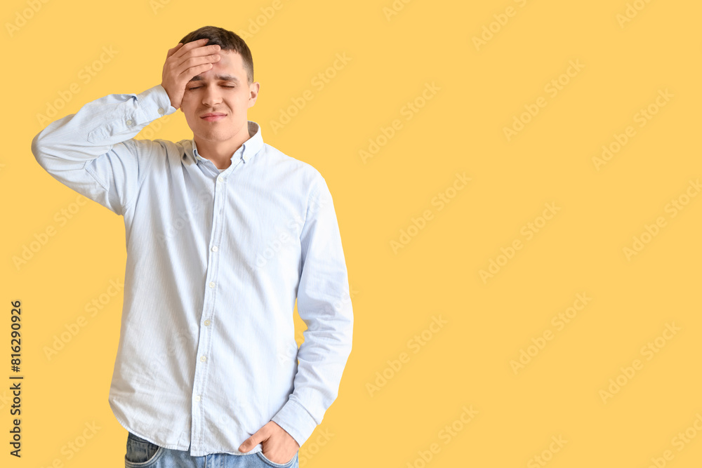 Young man with brain concussion on yellow background Young man with brain concussion on yellow background