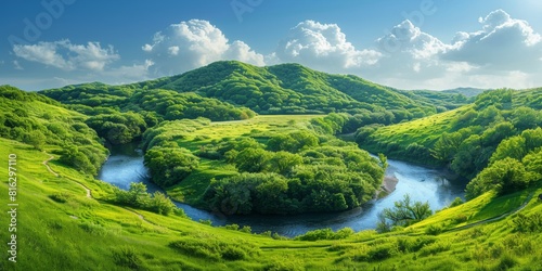 Stunning panoramic view of lush green hills with a meandering blue river under a bright sky with fluffy white clouds on a sunny day